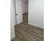 Bedroom with wood-look floors and access to another room at 5921 Se 4Th Pl, Ocala, FL 34472