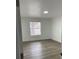 Bright bedroom with new wood-look flooring and a large window at 5921 Se 4Th Pl, Ocala, FL 34472