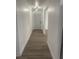 Bright hallway with light gray walls and wood-look flooring at 5921 Se 4Th Pl, Ocala, FL 34472