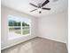 Bright bedroom with neutral walls, carpeting, and a large window at 6574 Se 108Th Ln, Belleview, FL 34420