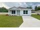 Newly built home with driveway and front yard at 6574 Se 108Th Ln, Belleview, FL 34420