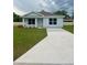 Newly built home with driveway and front yard at 6574 Se 108Th Ln, Belleview, FL 34420