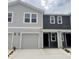 Stylish two-story townhome featuring a one-car garage and modern gray color scheme at 6590 Sw 81St Loop, Ocala, FL 34476