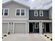 Charming townhouse featuring a blend of gray siding, attached garages, and neatly manicured landscaping at 6594 Sw 81St Loop, Ocala, FL 34476