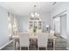 Elegant dining room with glass-top table and chandelier at 6695 Sw 64Th Ter, Ocala, FL 34476