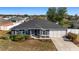 Single-story home with gray exterior, two-car garage, and landscaped yard at 6695 Sw 64Th Ter, Ocala, FL 34476