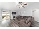 Living room with sectional sofa, fireplace, and hardwood floors at 6695 Sw 64Th Ter, Ocala, FL 34476