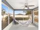 Relaxing screened porch with hammock and rocking chair, overlooking backyard at 6695 Sw 64Th Ter, Ocala, FL 34476