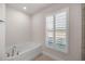 Relaxing bathroom with soaking tub and large window at 6836 Sw 179Th Court Rd, Dunnellon, FL 34432