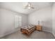 Cozy bedroom featuring a window with shutters and ceiling fan at 6836 Sw 179Th Court Rd, Dunnellon, FL 34432