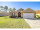 Front view of a house with a paver driveway at 6836 Sw 179Th Court Rd, Dunnellon, FL 34432