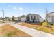 Single-story home with gray siding, white garage door, and landscaping at 7094 Sw 60Th Ln, Ocala, FL 34474