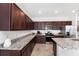 Modern kitchen with granite countertops and dark wood cabinets at 7094 Sw 60Th Ln, Ocala, FL 34474