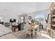 Open living room with a grey couch and wood dining table at 7094 Sw 60Th Ln, Ocala, FL 34474