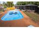 Inviting backyard pool with surrounding patio and floating rafts at 900 Mulberry St, Fruitland Park, FL 34731