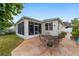 Enjoy this backyard patio with a screened porch and seating area at 1065 Ne 31St Ter, Ocala, FL 34470