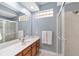 Well-lit bathroom with glass block window, walk-in shower, and modern fixtures at 1065 Ne 31St Ter, Ocala, FL 34470