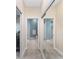 Clean bathroom with blue walls, tile floor, and mirrored closet at 1065 Ne 31St Ter, Ocala, FL 34470