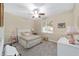 Charming bedroom with plush carpeting, a decorative ceiling fan, and a well-lit window at 1065 Ne 31St Ter, Ocala, FL 34470