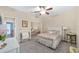 Bedroom with mirrored closet doors and ceiling fan at 1065 Ne 31St Ter, Ocala, FL 34470