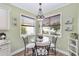 Charming breakfast nook with glass-top table and window seating at 1065 Ne 31St Ter, Ocala, FL 34470