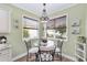 Cozy breakfast nook with decorative chandelier lighting and views to the outside at 1065 Ne 31St Ter, Ocala, FL 34470