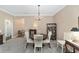 Dining room with round table, chandelier, and seamless flow to other rooms at 1065 Ne 31St Ter, Ocala, FL 34470