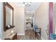 Inviting entryway with wood floors, decorative mirror, stylish bench, and elegant lighting at 1065 Ne 31St Ter, Ocala, FL 34470