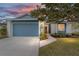 Charming one-story home with a blue garage door and landscaped lawn at 1065 Ne 31St Ter, Ocala, FL 34470