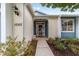 House exterior showcasing a blue door and well maintained lawn at 1065 Ne 31St Ter, Ocala, FL 34470