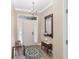 Inviting foyer with hardwood floors, elegant lighting fixture, and a decorative mirror creating a welcoming atmosphere at 1065 Ne 31St Ter, Ocala, FL 34470