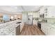 Open kitchen with stainless steel appliances, granite countertops, and wood flooring at 1065 Ne 31St Ter, Ocala, FL 34470
