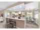 Well-lit kitchen with stainless steel appliances, granite countertops, and breakfast bar at 1065 Ne 31St Ter, Ocala, FL 34470