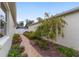 Landscaped walkway alongside home with well-maintained shrubs, trees, and flowers at 1065 Ne 31St Ter, Ocala, FL 34470