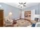 Cozy sitting area showcasing a round rug and access to the dining room beyond double doors at 1065 Ne 31St Ter, Ocala, FL 34470