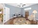 Cozy living room featuring hardwood floors, a ceiling fan, and light blue walls for a relaxing atmosphere at 1065 Ne 31St Ter, Ocala, FL 34470