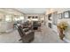 Bright, open living space featuring a fireplace, bar seating, and access to a screened patio at 1065 Ne 31St Ter, Ocala, FL 34470