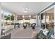 Inviting screened lanai with stylish seating, an outdoor grill, and comfortable outdoor rug at 1065 Ne 31St Ter, Ocala, FL 34470