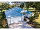 Single-story home with gray roof and white garage door, overlooking a golf course at 10801 Sw 71St Ave, Ocala, FL 34476