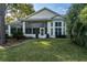 House back view with a screened porch and beautifully landscaped yard at 10801 Sw 71St Ave, Ocala, FL 34476