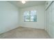 Simple bedroom with neutral carpeting, window, and double door closet at 10801 Sw 71St Ave, Ocala, FL 34476