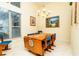 Bright dining room featuring a wood table with blue chairs and large window at 10801 Sw 71St Ave, Ocala, FL 34476