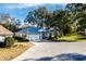 House exterior with a white garage door and American flag at 10801 Sw 71St Ave, Ocala, FL 34476