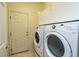 Well-lit laundry room, featuring a washer and dryer, and built-in shelving at 10801 Sw 71St Ave, Ocala, FL 34476