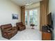 Relaxing living room with two brown leather recliners and large window at 10801 Sw 71St Ave, Ocala, FL 34476