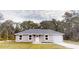 Single-story home with a grey roof and attached garage at 111 Fisher Trace Dr, Ocklawaha, FL 32179