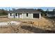 Newly constructed home with gray siding and a gray shingle roof at 111 Fisher Trace Dr, Ocklawaha, FL 32179