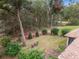 Landscaped backyard with a small sitting area and wooded backdrop at 19586 Sw 84Th Pl, Dunnellon, FL 34432