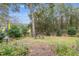 Landscaped backyard with sitting area and lush greenery at 19586 Sw 84Th Pl, Dunnellon, FL 34432