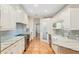 Clean kitchen featuring white cabinets, granite countertops, and farm sink at 19586 Sw 84Th Pl, Dunnellon, FL 34432